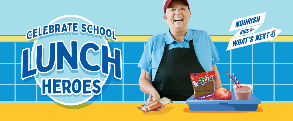 Celebrate school lunch heroes in dark blue text outlined in white over light blue circle. White female foodservice operator wearing maroon visor, light blue polo shirt and black apron standing at a yellow illustrated countertop. Blue cafeteria tray with yogurt parfait, apple, and Trix french toast in package. Operator holds mini cinnis in package. Background is illustrated light blue wall, medium blue tile with yellow border.