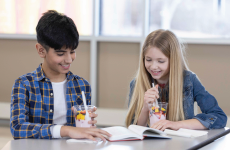 Two students eating parfaits and studying